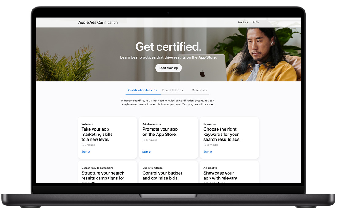 A MacBook showing the Apple Ads Certification home page.